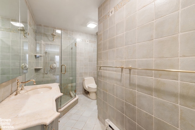 40 E 80th St Unit 3A, New York City, NY 10021 - bathroom featuring tile walls, tile patterned flooring, vanity, a stall shower, and toilet