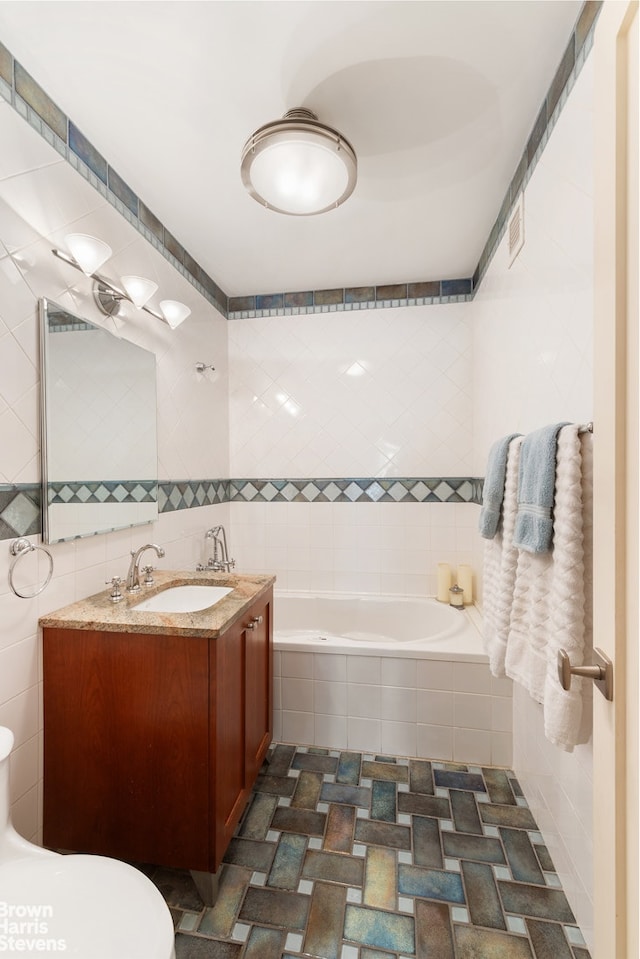 40 E 80th St Unit 3A, New York City, NY 10021 - full bath featuring tile walls, a bath, toilet, and double vanity