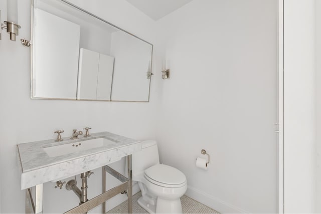 408 E 79th St Unit 3B, New York City, NY 10075 - bathroom featuring toilet, tile patterned floors, baseboards, and a sink