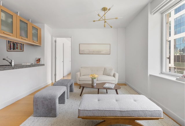 408 E 79th St Unit 3B, New York City, NY 10075 - living room with healthy amount of natural light, wood finished floors, and baseboards