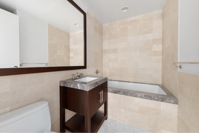 408 E 79th St Unit 3B, New York City, NY 10075 - full bathroom featuring tile walls, tiled tub, toilet, vanity, and tile patterned flooring