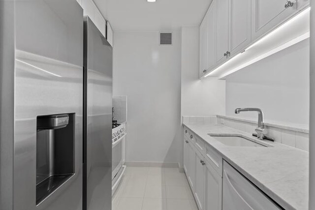 200 Riverside Blvd Unit 30-B, New York City, NY 10069 - kitchen with appliances with stainless steel finishes, a sink, white cabinets, and light tile patterned floors
