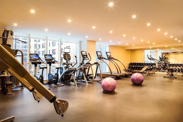 exercise room featuring expansive windows and recessed lighting