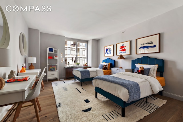 bedroom with baseboards and wood finished floors