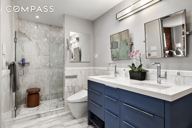 bathroom featuring toilet, a shower stall, a sink, and marble finish floor