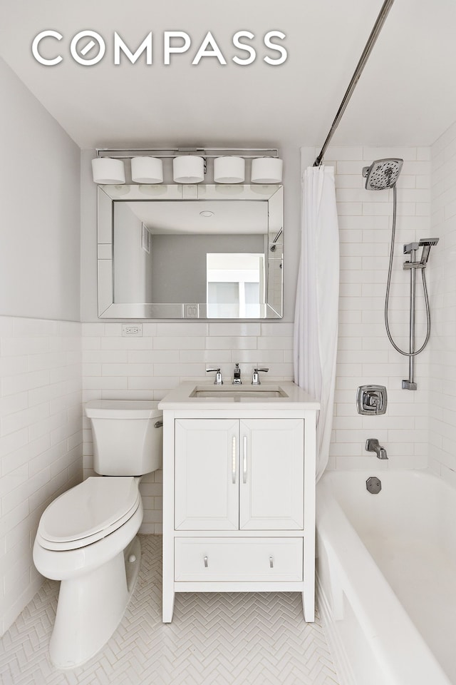 49 W 12th St Unit 1A, New York City, NY 10011 - full bath featuring vanity, toilet, shower / tub combo, and tile walls