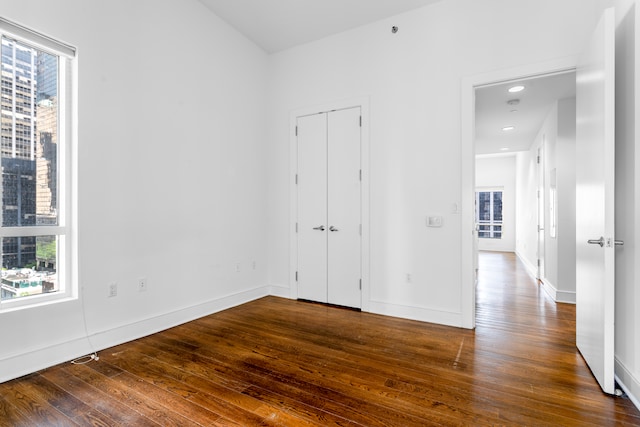 250 E 49th St Unit 10A, New York City, NY 10017 - unfurnished room with plenty of natural light, dark wood-style flooring, and baseboards
