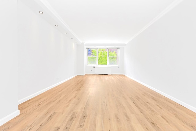 305 E 24th St Unit 3-T, New York City, NY 10010 - spare room featuring crown molding, light wood-type flooring, and baseboards