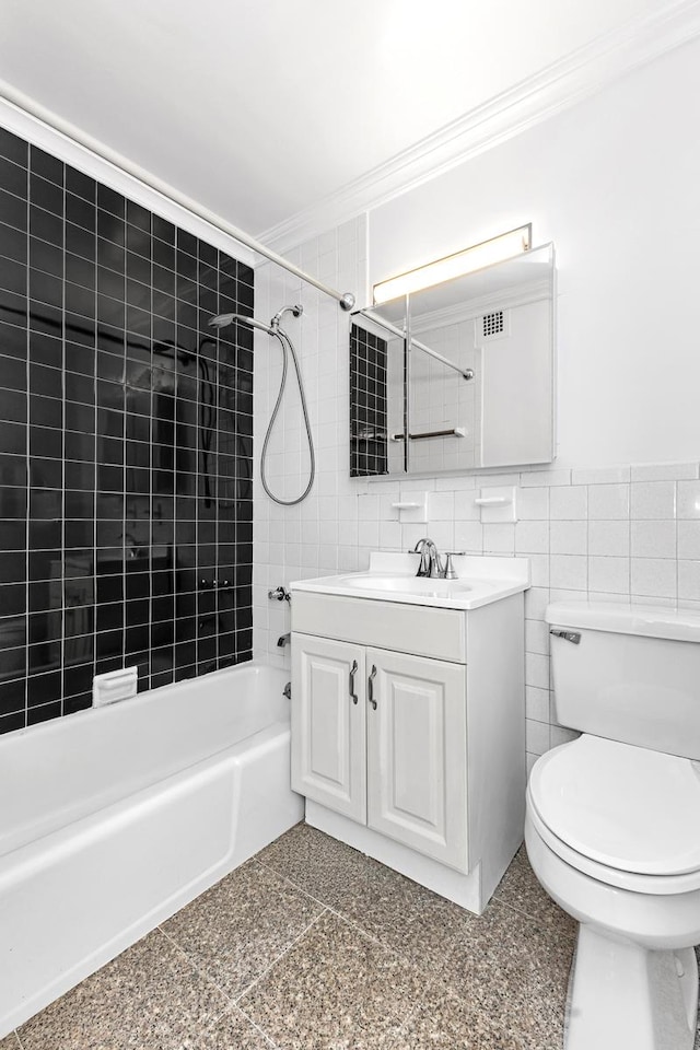305 E 24th St Unit 3-T, New York City, NY 10010 - bathroom featuring ornamental molding, shower / bathtub combination, tile walls, vanity, and toilet