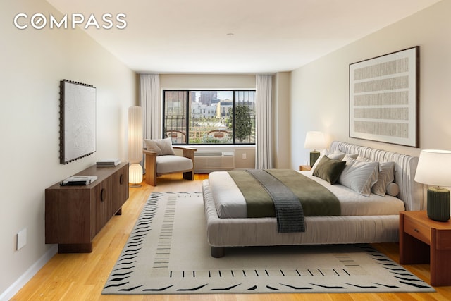 bedroom with light wood finished floors and baseboards