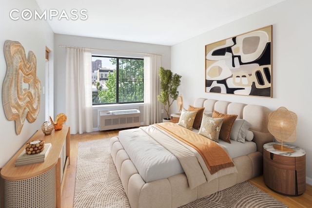 416 E 117th St Unit 5A, New York City, NY 10035 - bedroom featuring wood finished floors and a wall mounted AC