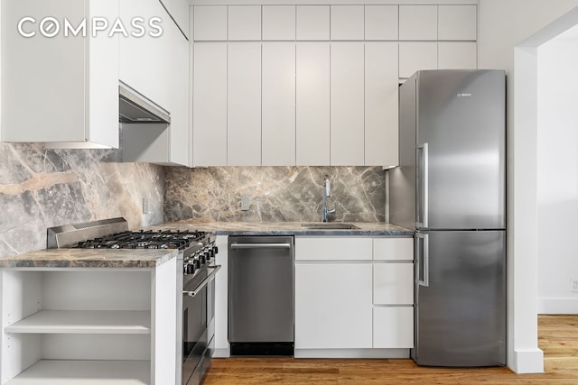 kitchen with stainless steel appliances, open shelves, a sink, and modern cabinets