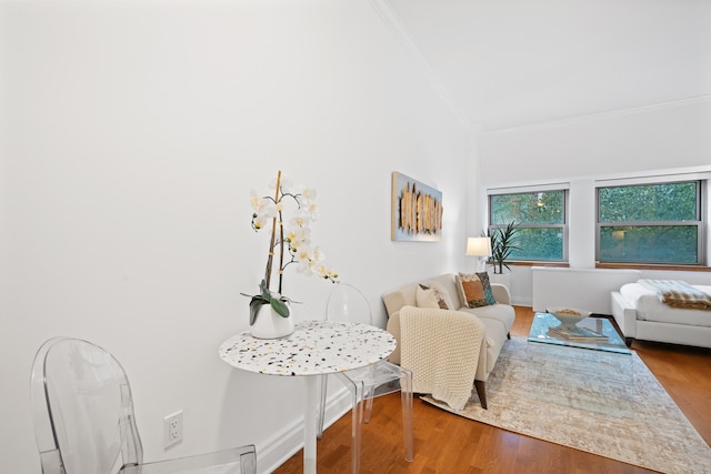 living room featuring ornamental molding and wood finished floors