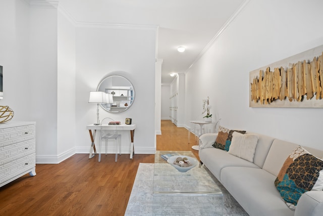 living room with crown molding, baseboards, and wood finished floors