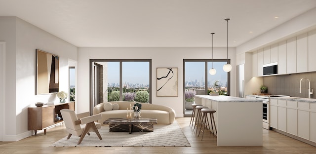 living area with recessed lighting, light wood-style flooring, and baseboards