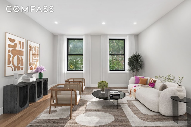 living area featuring recessed lighting, baseboards, and wood finished floors