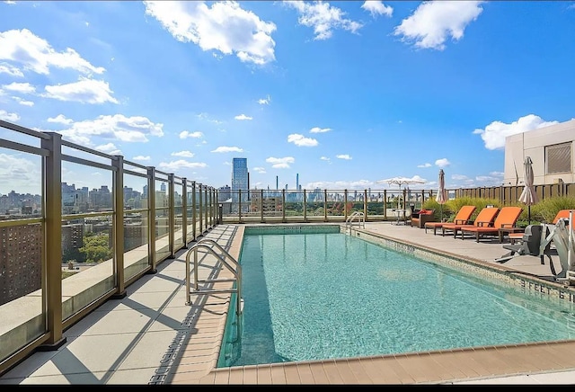 pool featuring fence and a patio area