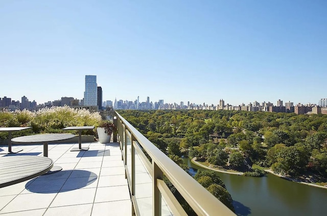 balcony featuring a city view and a water view