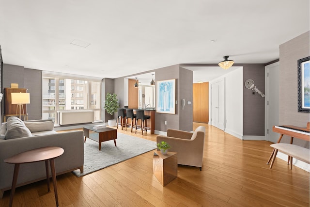 living area with baseboards and hardwood / wood-style flooring