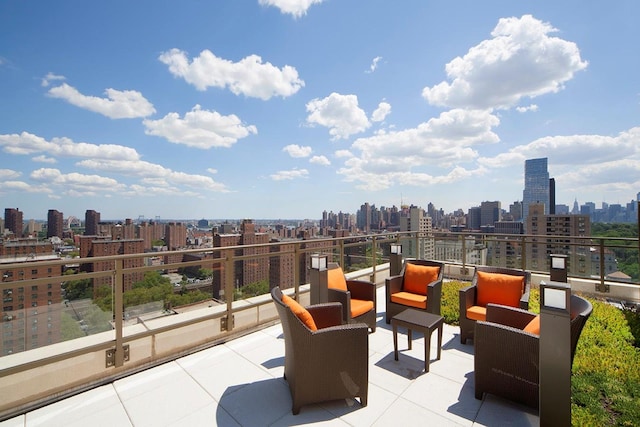 view of patio featuring a balcony, a city view, and an outdoor hangout area
