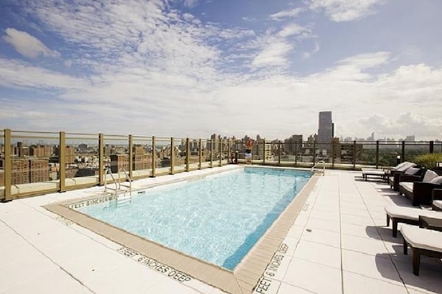 pool featuring fence and a patio area