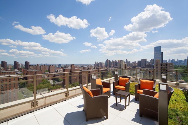 view of patio / terrace with an outdoor living space, a balcony, and a city view