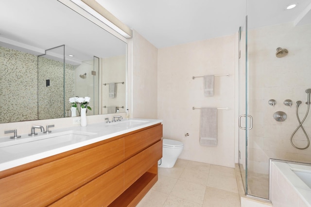 full bath with a sink, tile patterned flooring, a stall shower, and double vanity