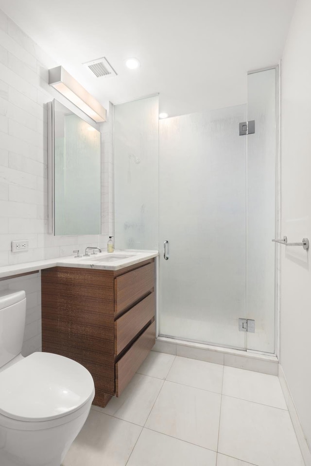 bathroom with visible vents, tile patterned flooring, a stall shower, vanity, and toilet