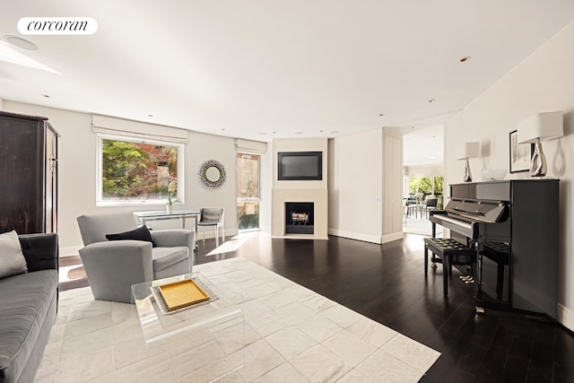 living room featuring visible vents, a fireplace, wood finished floors, baseboards, and recessed lighting