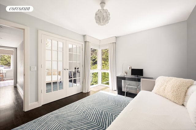 bedroom featuring baseboards, french doors, wood finished floors, and visible vents