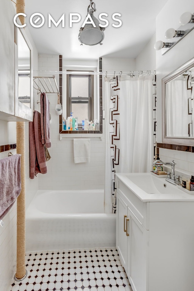 full bathroom with tile patterned flooring, shower / tub combo with curtain, and vanity