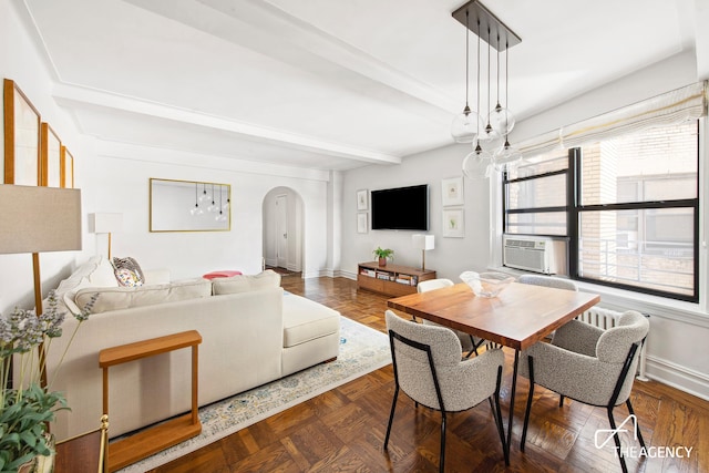 dining room featuring arched walkways, baseboards, cooling unit, and beam ceiling