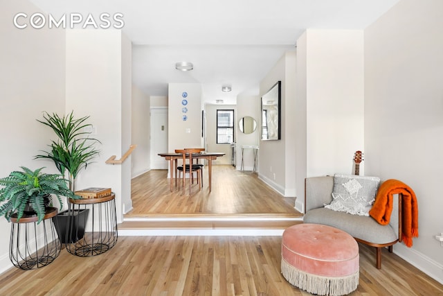 hallway featuring baseboards and light wood finished floors