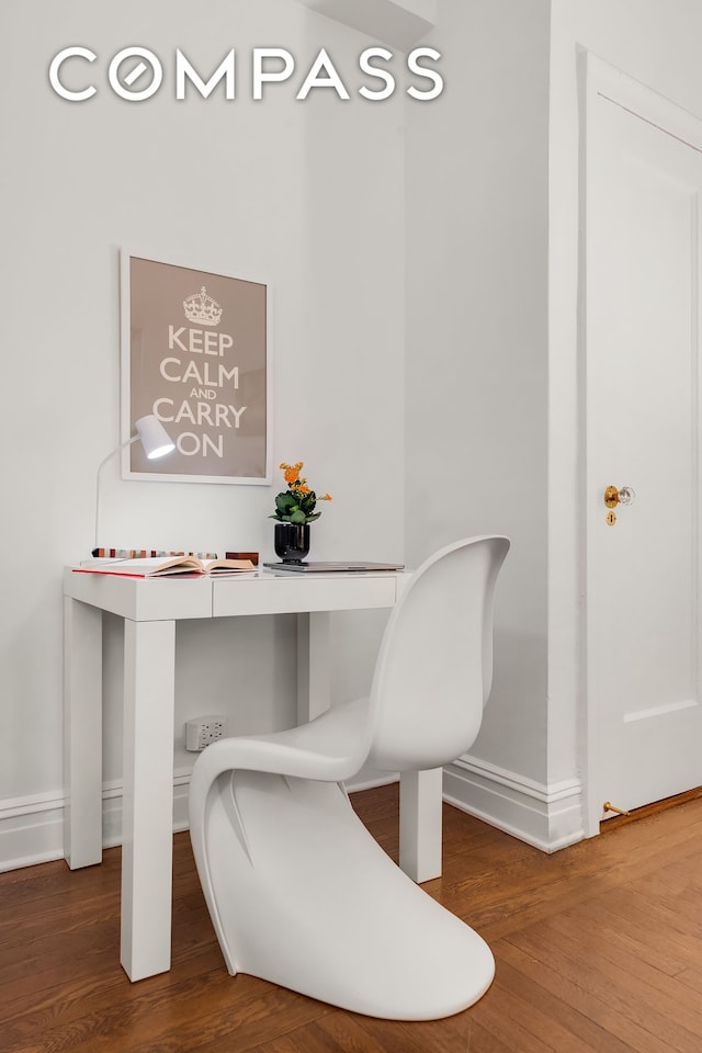 office space featuring baseboards and wood finished floors