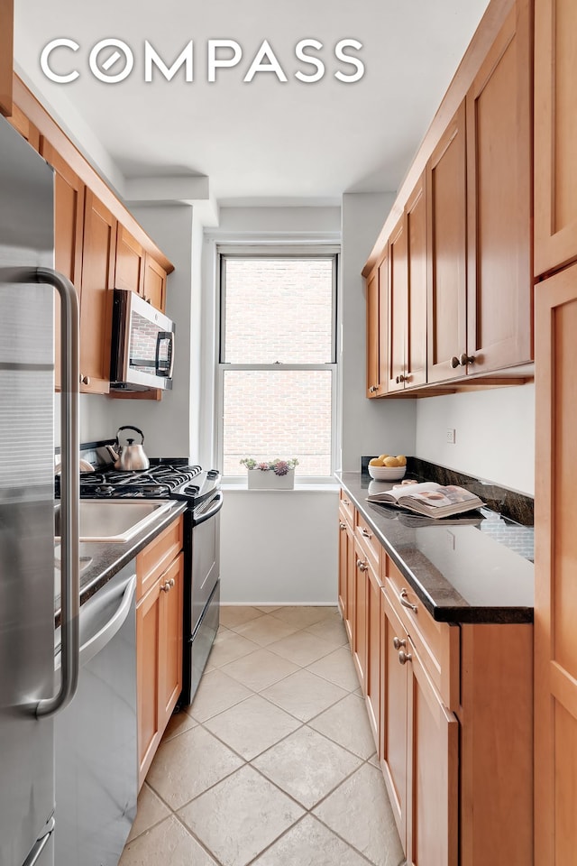 16 E 98th St Unit 8D, New York City, NY 10029 - kitchen featuring stainless steel appliances and light tile patterned floors