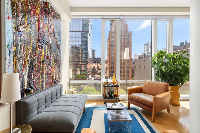 245 W 99th St Unit 7B, New York City, NY 10025 - living area with a skyline view, wood finished floors, and plenty of natural light