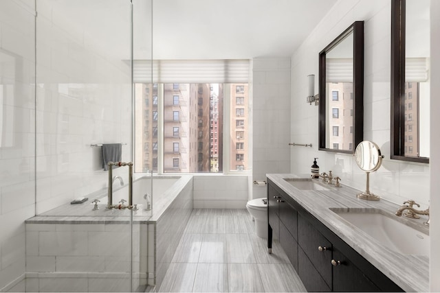 245 W 99th St Unit 7B, New York City, NY 10025 - bathroom with double vanity, toilet, tiled tub, and a shower with shower door