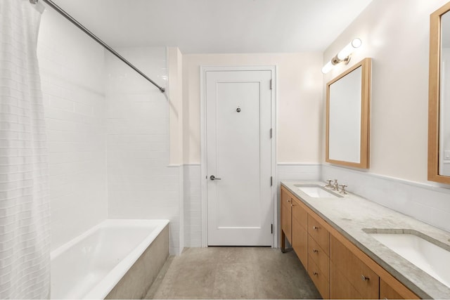 245 W 99th St Unit 7B, New York City, NY 10025 - bathroom with double vanity, shower / bathtub combination with curtain, and wainscoting