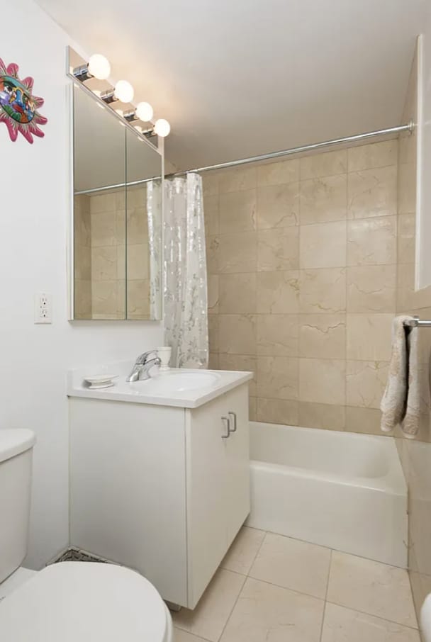 304 W 88th St Unit 1D, New York City, NY 10024 - bathroom with vanity, shower / bathtub combination with curtain, tile patterned floors, and toilet