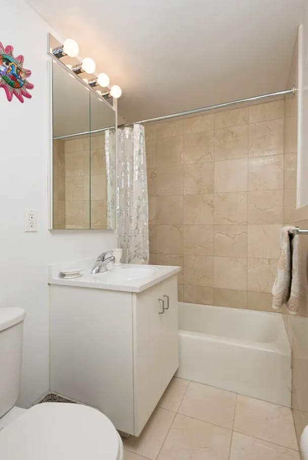 304 W 88th St Unit 1D, New York City, NY 10024 - bathroom with vanity, tile patterned flooring, and shower / bath combo