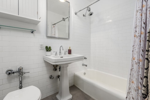 77 7th Ave Unit 7Kk, New York City, NY 10011 - full bathroom with tile walls, shower / bath combination with curtain, toilet, tile patterned flooring, and a sink