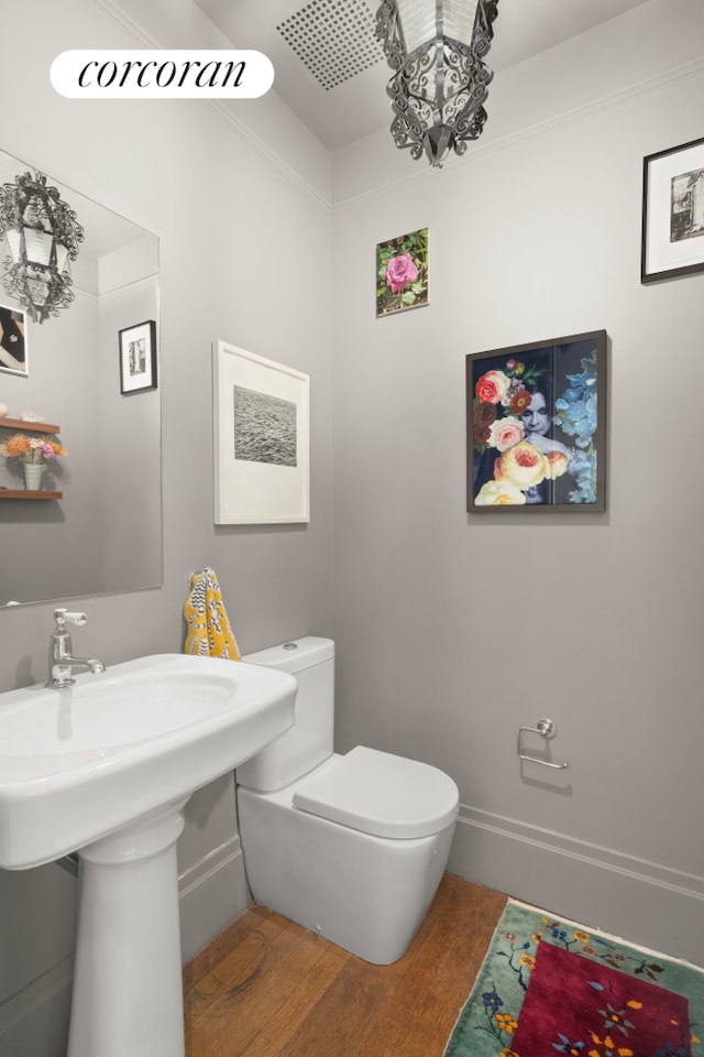 61 Pierrepont St Unit 51/52, New York City, NY 11201 - half bath with wood finished floors, toilet, and baseboards