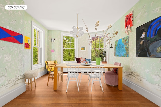 61 Pierrepont St Unit 51/52, New York City, NY 11201 - dining room featuring wallpapered walls, a chandelier, wood finished floors, and baseboards