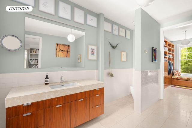 61 Pierrepont St Unit 51/52, New York City, NY 11201 - bathroom with tile walls, tile patterned floors, vanity, toilet, and a walk in closet