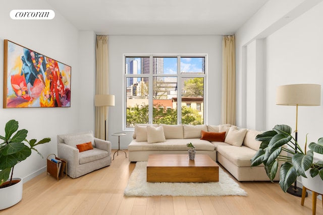 living area featuring visible vents and wood finished floors