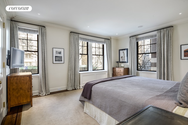 bedroom with crown molding, baseboards, multiple windows, and visible vents