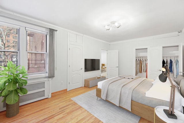 bedroom with crown molding and light wood-style flooring