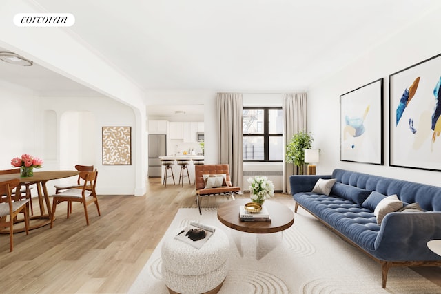 3000 Valentine Ave Unit 5J, New York City, NY 10458 - living area with arched walkways, light wood-type flooring, radiator, and baseboards