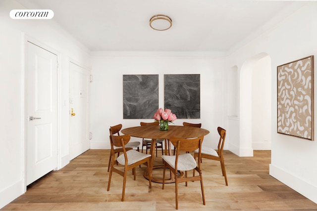 3000 Valentine Ave Unit 5J, New York City, NY 10458 - dining room with light wood finished floors, arched walkways, and baseboards