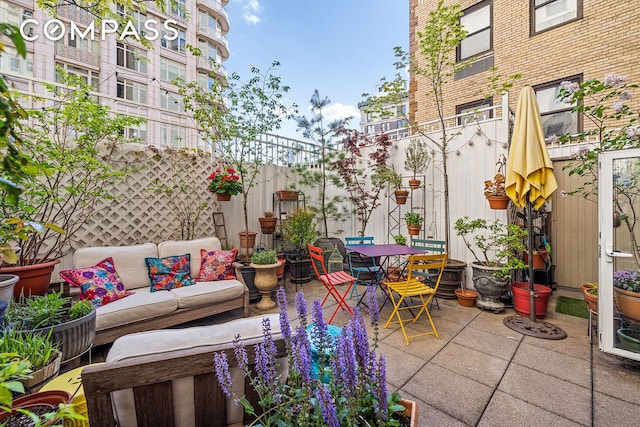 view of patio / terrace featuring outdoor lounge area, outdoor dining area, and fence